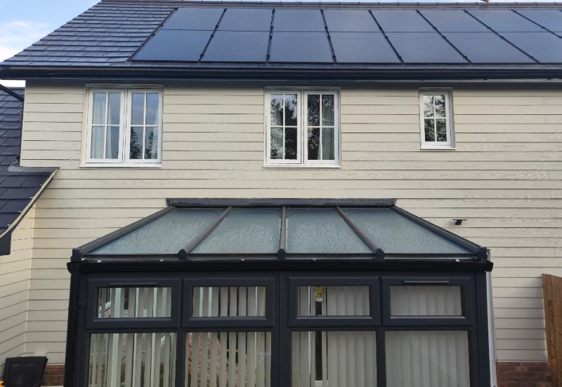 Insulated conservatory with modern roof panels and windows, showcasing a home transformation by Rosy Roof.