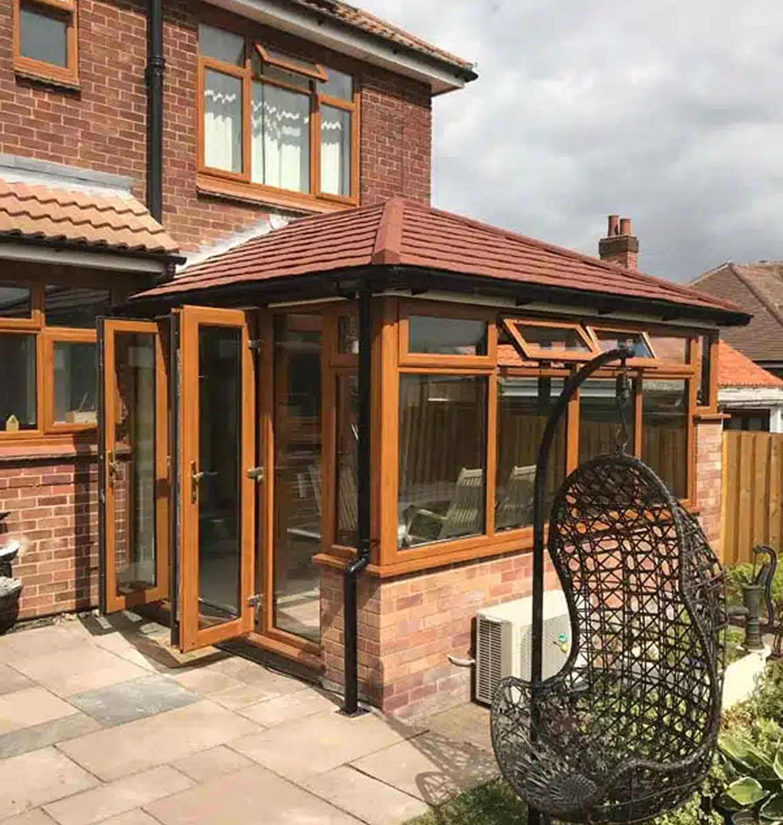 Conservatory with lightweight tiled roof and wooden frames, showcasing excellent thermal performance and traditional aesthetics in Basingstoke.